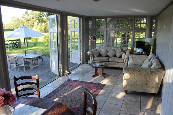 Casa de campo Deluxe | Área de sala de estar | Televisión de pantalla plana de 33 pulgadas con canales digitales