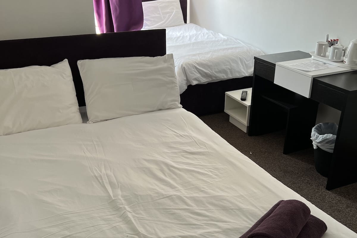 Laptop workspace, bed sheets
