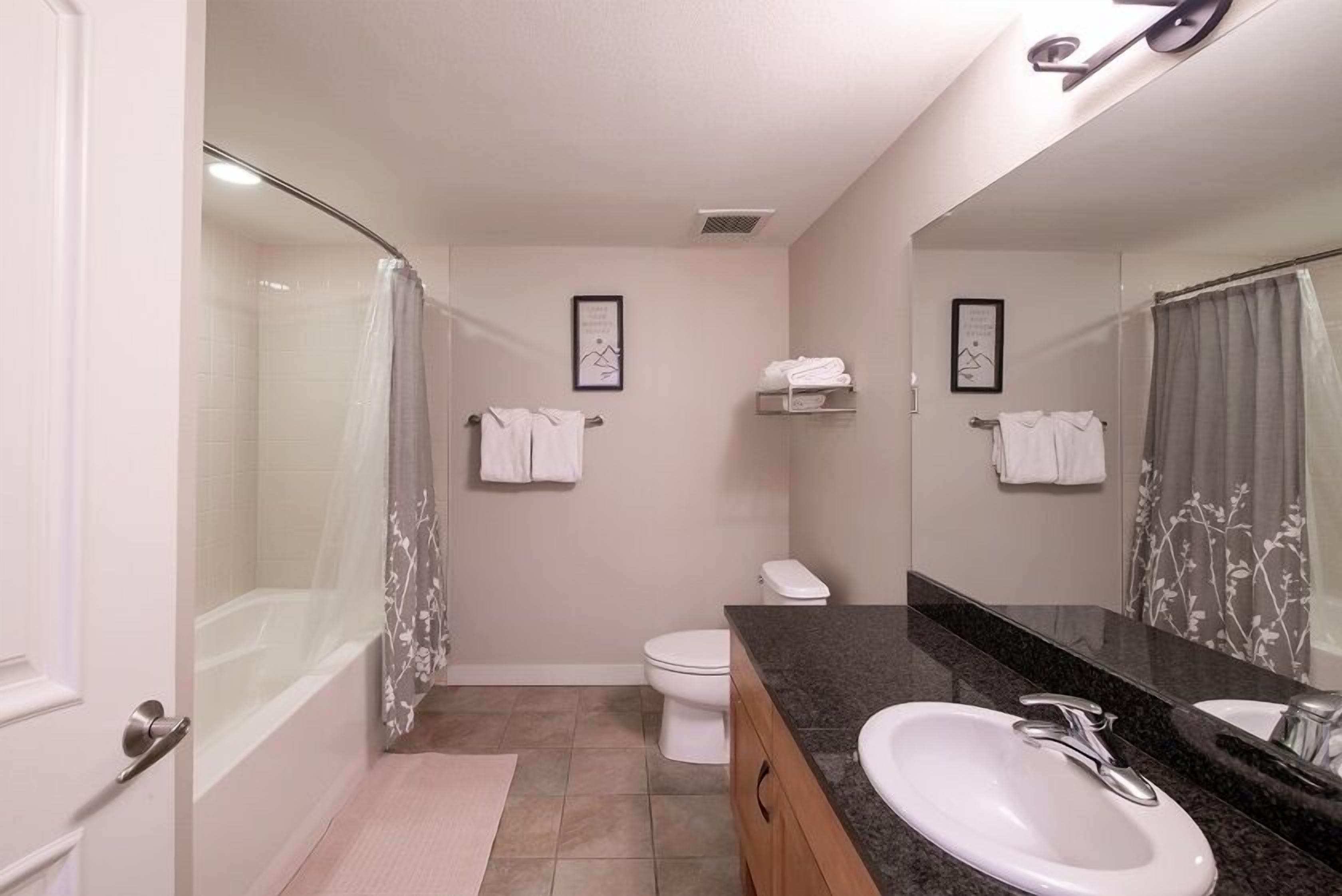 Un baño moderno con bañera, inodoro y lavamanos.