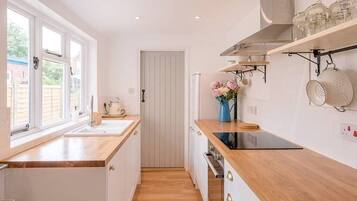 Fridge, stovetop, cookware/dishes/utensils, dining tables