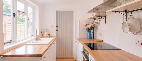 Fridge, stovetop, cookware/dishes/utensils, dining tables