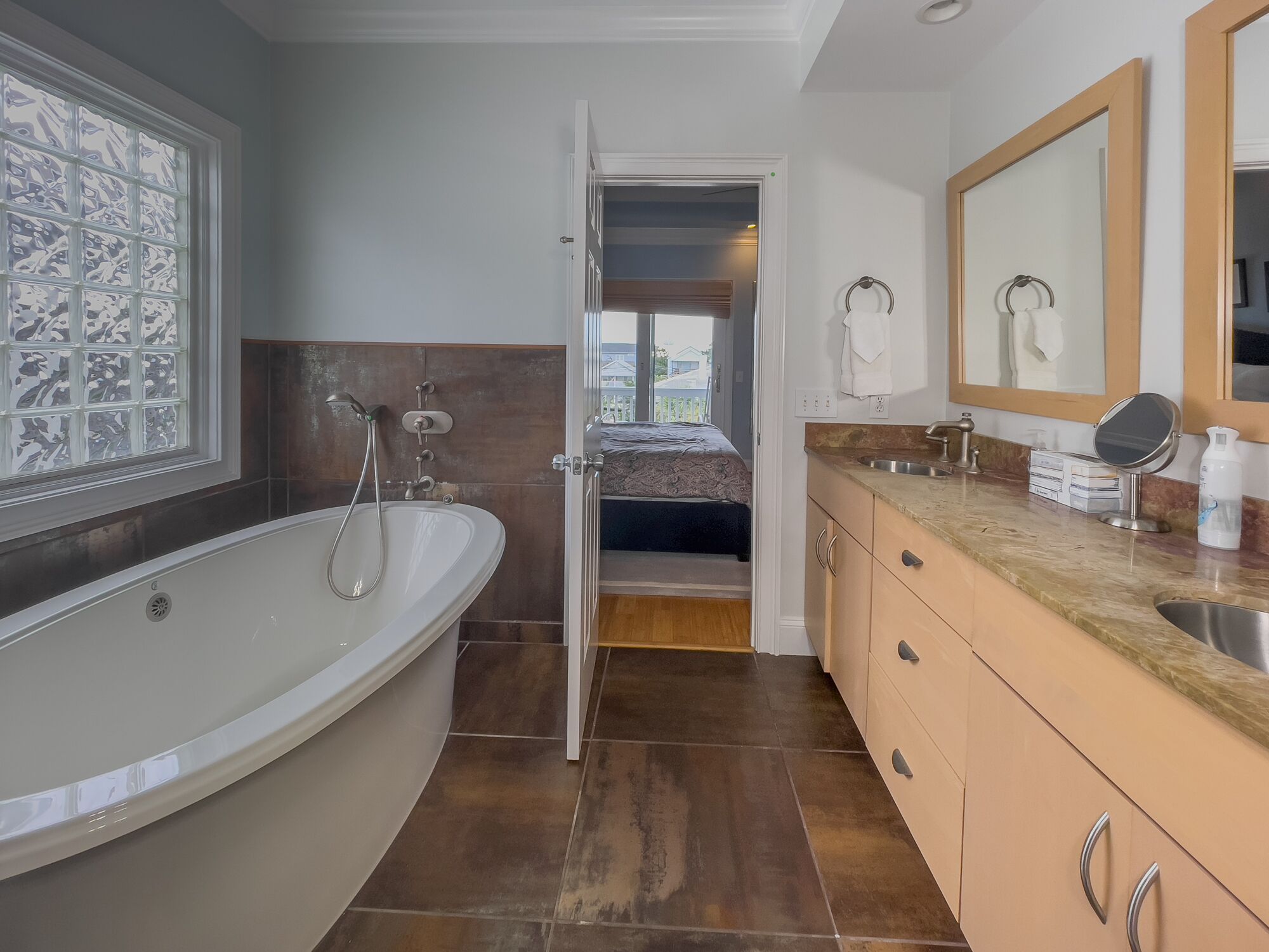 Un baño moderno con una bañera independiente, ducha y tocador con espejo.