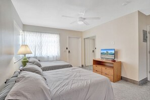 Laptop workspace, iron/ironing board, bed sheets