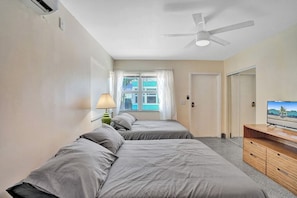 Laptop workspace, iron/ironing board, bed sheets