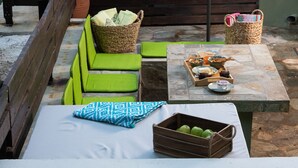 An outdoor seating area with a pool, green chairs, a table with food, and a wooden bench. - DandyVillas Tsagkarada | Sweet Green Apple | Mini Pool (Tsagkarada)