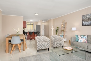 Deluxe Apartment | Living area | 50-inch flat-screen TV with cable channels, TV