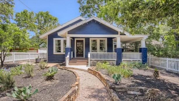 A single-story house with a front porch, a covered entryway, and a fenced yard. - Spacious 2/2 Home Prime Location Mins to DT/SOCO & SXSW Top Spots (Austin)