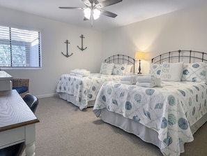A bedroom with two beds, a ceiling fan, a window with blinds, and a lamp. - 482 Plantation Club at The Sea Pines Resort (Hilton Head Island)