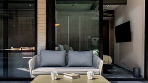 A modern living area with a sofa, a coffee table, and a book.