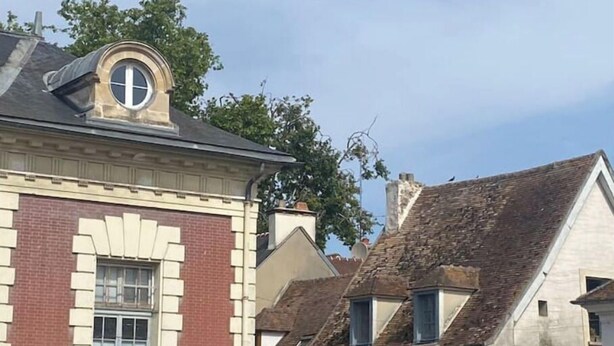 A traditional building with a prominent arched window and a brick facade.