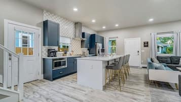 Enjoy cooking and socializing in this well-equipped kitchen and living area with a central island and comfortable seating.