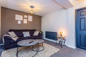 Relax in this inviting living room with a sofa, coffee table, and lamp.