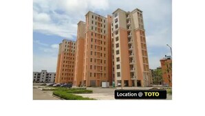 A multi-story residential building with a modern architectural design, featuring a central courtyard and a parking area in front. - Explore Rajasthan's rich cultural heritage in NCR (Neemrana)