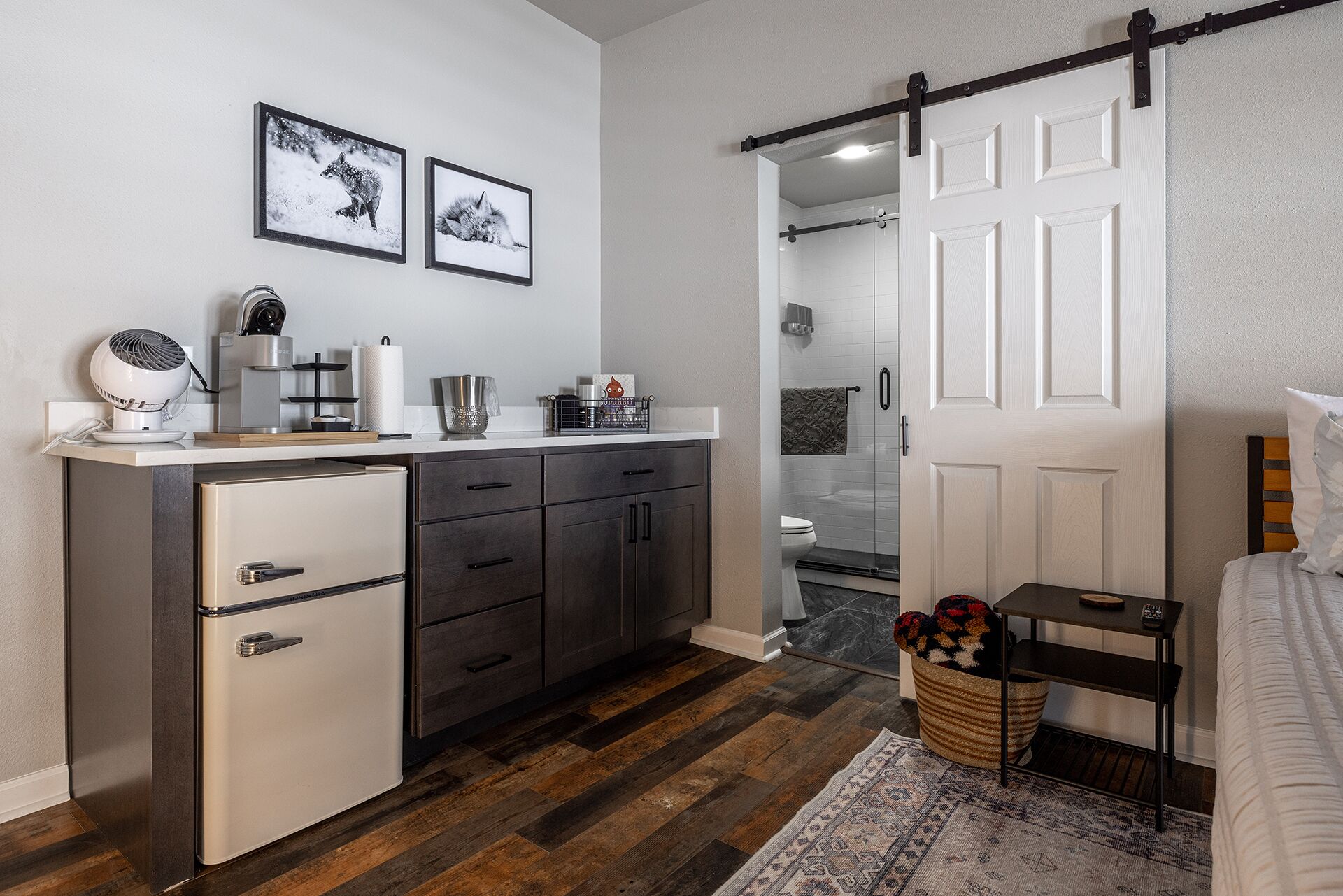 A modern bathroom with a shower, toilet, and a vanity with a sink and mirror.
