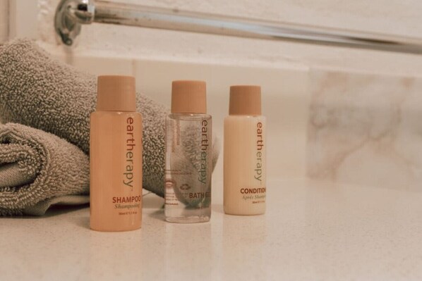 Three bottles of Earththerapy products on a bathroom counter.
