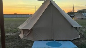 A tent with a canopy and a lantern on the ground. - Cozy Bell Tent Retreat at Lake Texoma (Kingston)