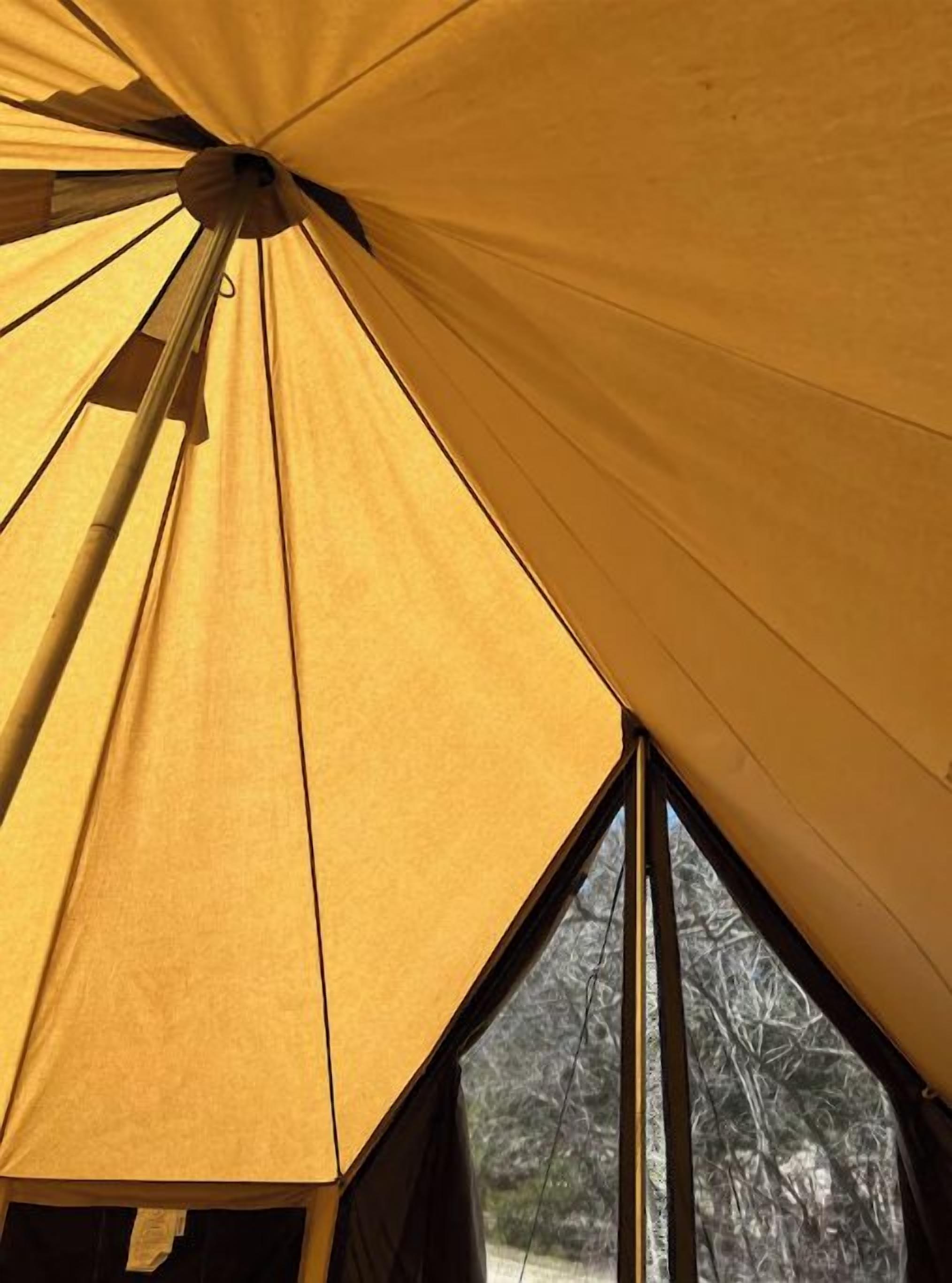 A tent with a peaked roof and a window.