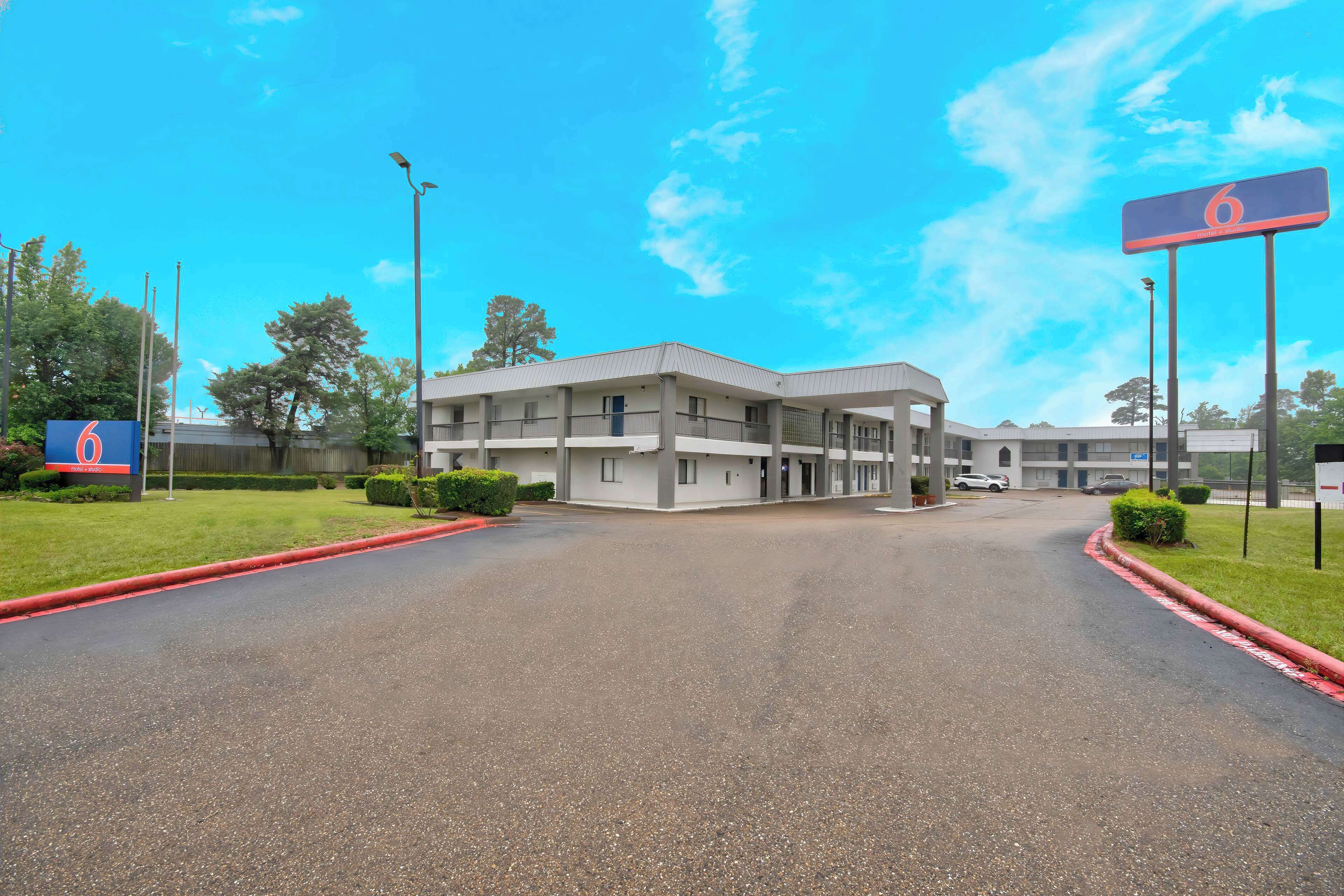 A motel with a central building and a parking lot.