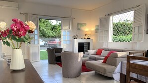 A modern living room with a sofa set, a coffee table, and a vase with flowers. - Magnificent villa with free parking ideally located. (Schoelcher)
