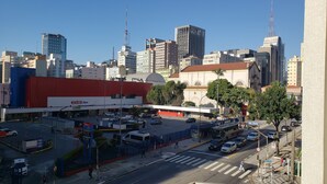 A cityscape with a prominent red building labeled "extra hyper" and a variety of modern high-rise buildings in the background. - Apto. Completo Prox a av. Paulista (São Paulo)