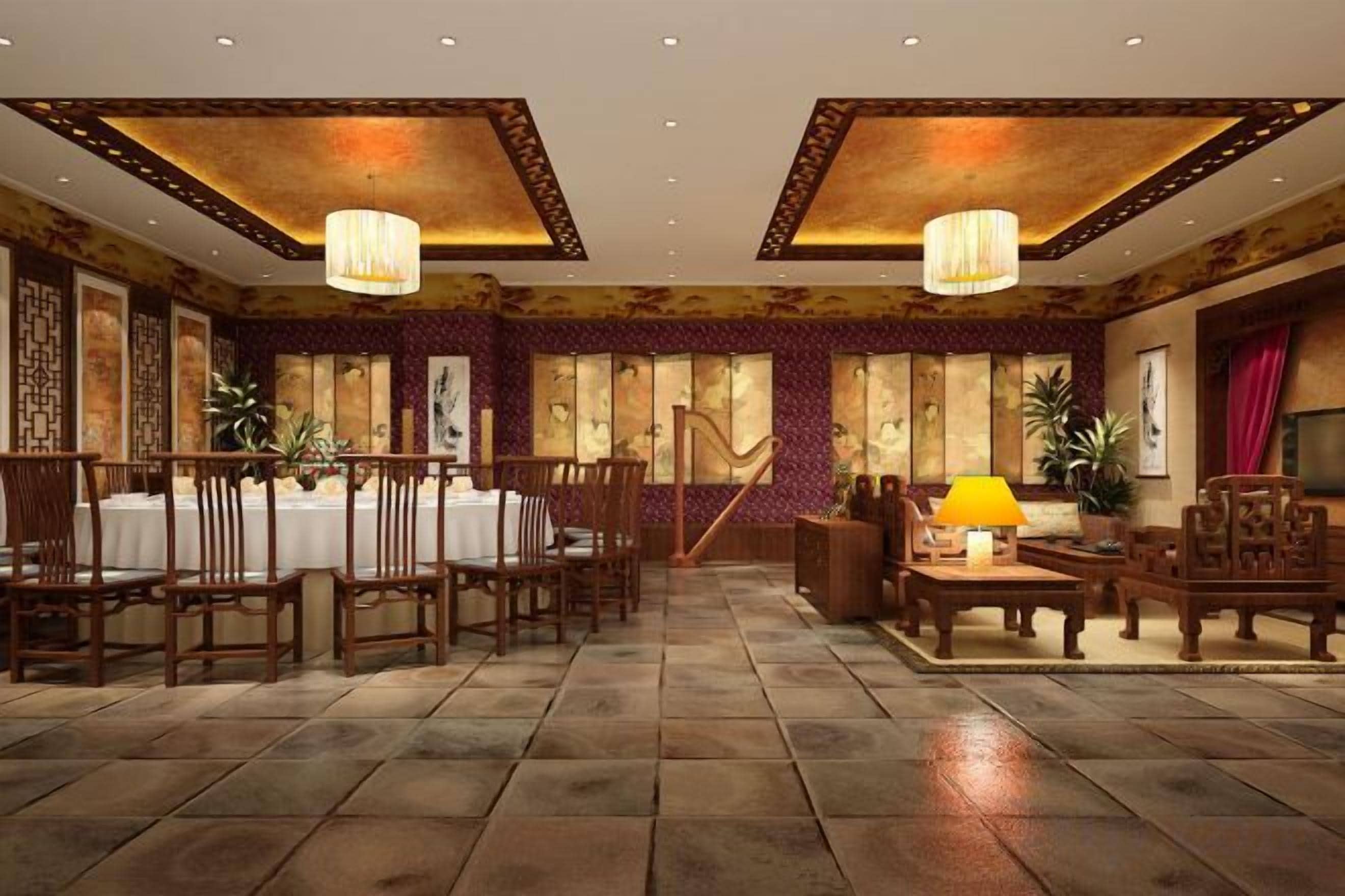 A spacious dining area with a long table, multiple chairs, and a staircase leading to an upper level.
