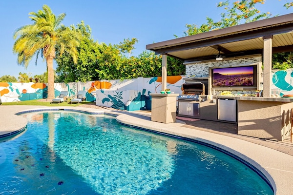 Resort-style backyard with heated pool, hot tub and outdoor kitchen and bar.