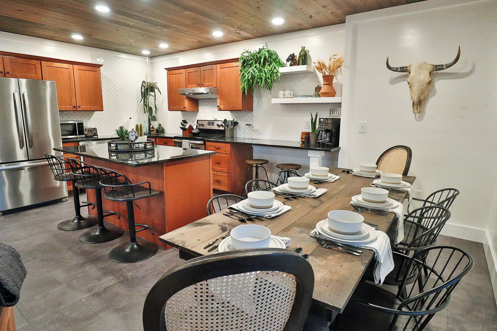 Open fully equipped kitchen, dining area, and living room.