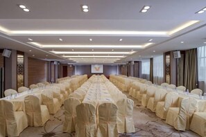 A conference room with long tables, chairs, and a podium. - Southern Yijing Intenational Hotel (Dongguan Fengshen Avenue) (Dongguan)