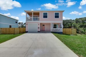 Stunning two-story residence with a central entrance, flanked by upper-floor windows and a charming ground-floor porch.