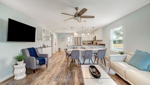 A modern kitchen with a central island, dining area with chairs, and a living room with a sofa and coffee table. - Seascape - Yellow🌼PRIVATE POOL✔️3-MIN WALK to BCH✔️ (Butler Beach)