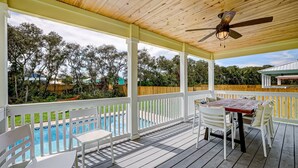 A covered outdoor deck with a pool, white furniture, and a ceiling fan. - Seascape - Yellow🌼PRIVATE POOL✔️3-MIN WALK to BCH✔️ (Butler Beach)