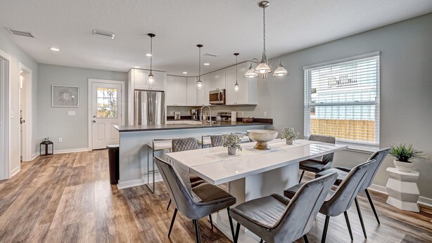 A modern kitchen with white cabinets, a central island, and pendant lighting. - Seascape - Yellow🌼PRIVATE POOL✔️3-MIN WALK to BCH✔️ (Butler Beach)