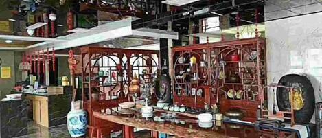 A traditional Chinese tea house with wooden furniture and tea sets.
