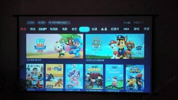 A digital display with various animated characters and game icons.