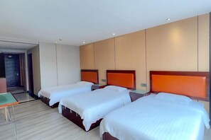 A hotel room with three single beds, a small table, and a view of the hallway. - Feiyang 88 Hotel (Guangzhou Panyu Plaza) (Guangzhou)