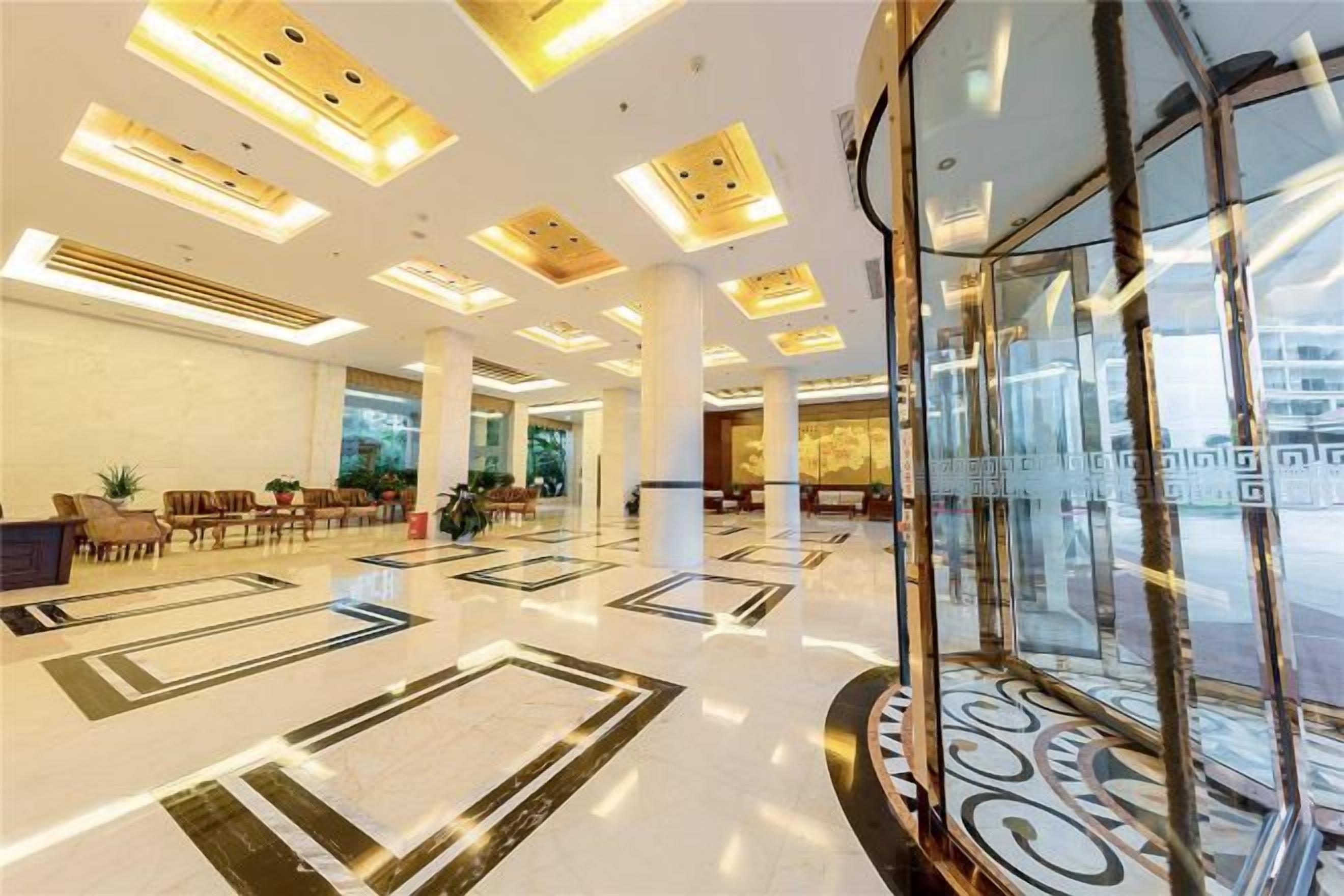 A spacious lobby with a high ceiling, large windows, and a central column.