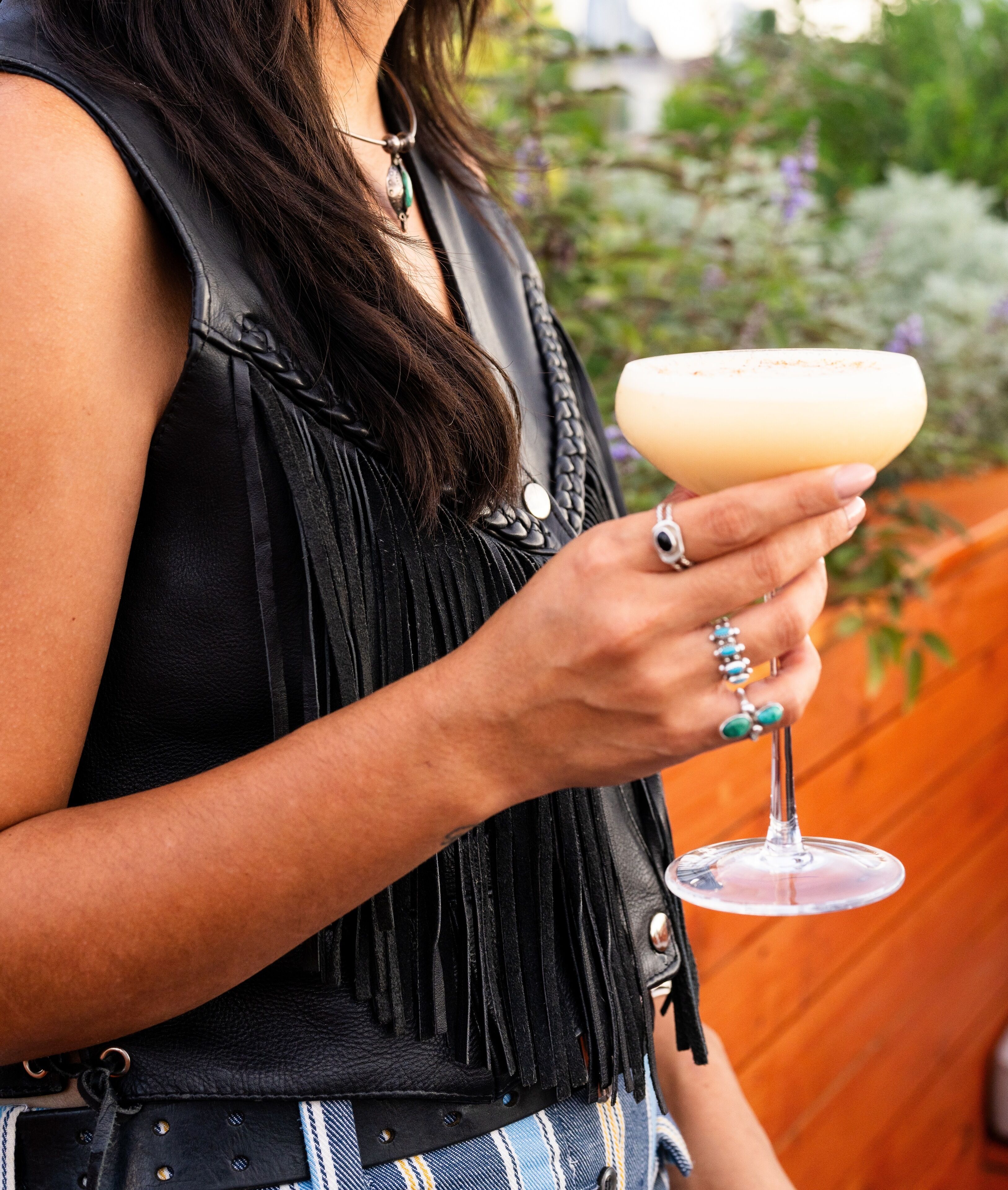 A person holding a cocktail glass.