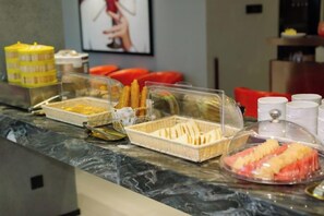 A buffet counter with various food items and containers. - Guang Ao Hotel (Haikou)