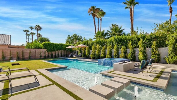 A swimming pool with a hot tub, lounge chairs, and palm trees. - Multi month discount,luxury,entertaining +relaxing (Cathedral City)