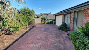 A brick pathway leading to a house with a garage and a covered driveway. - City Edge Lower Plenty (Lower Plenty)