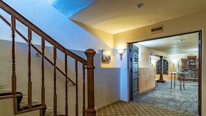 A staircase with wooden balusters leading to a tiled floor. - Penthouse King Suite•Private Floor•Monterey (Salinas)