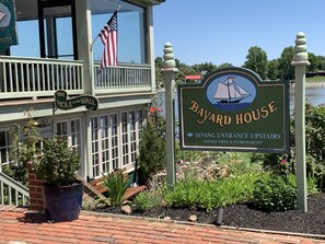 A sign for Bayard House with a dining entrance upstairs and a smoke-free environment.