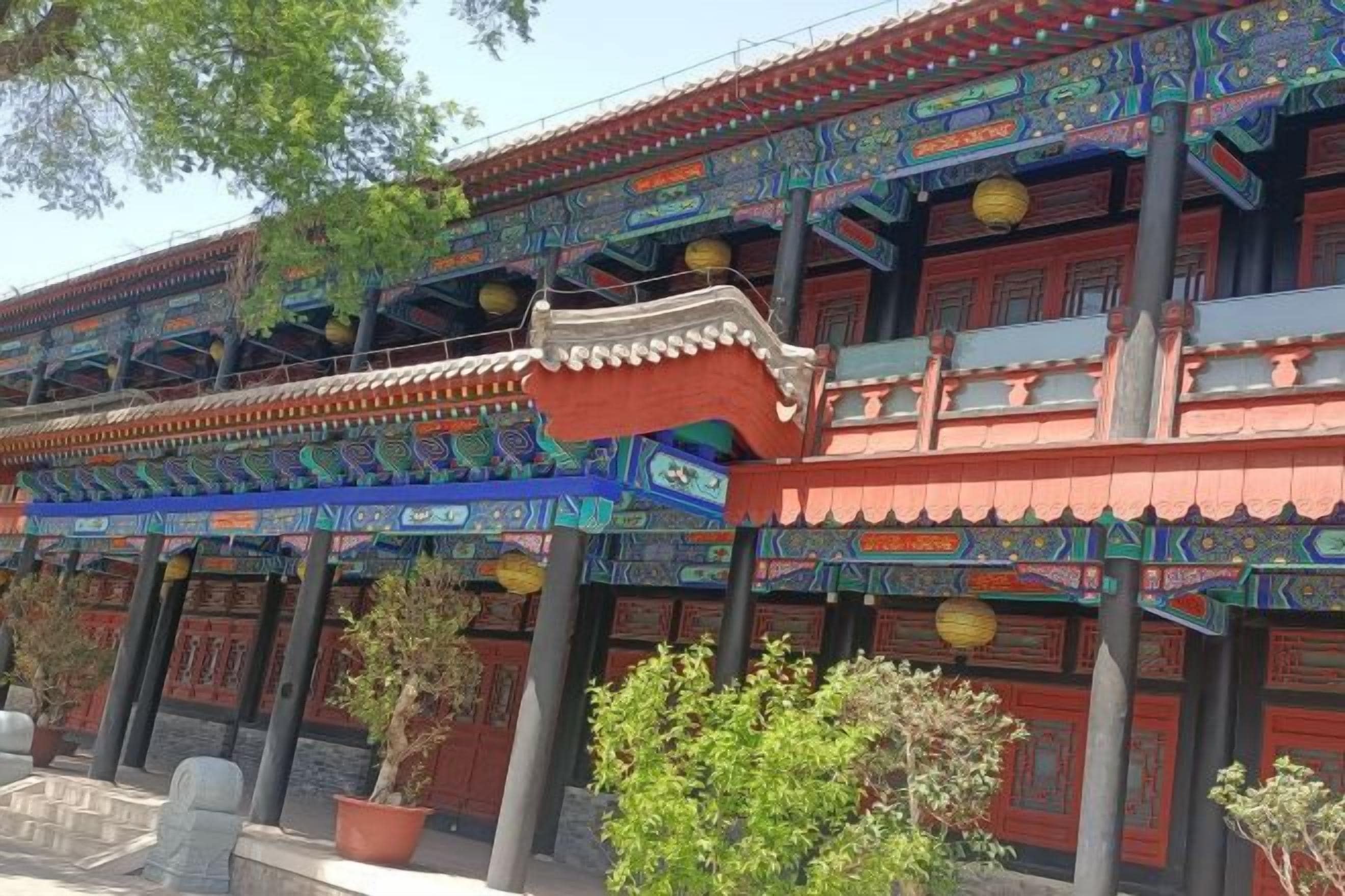 A traditional building with multiple levels, ornate decorations, and a series of columns.
