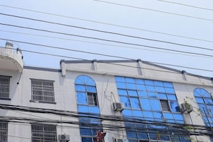 A building with multiple windows and air conditioning units.