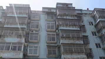 A multi-story building with numerous windows and balconies.