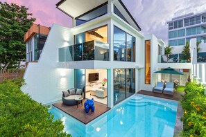 A modern two-story house with a swimming pool, a balcony, and a well-maintained garden. - 3br Luxury Beachfront Pool Villa (Rawai)