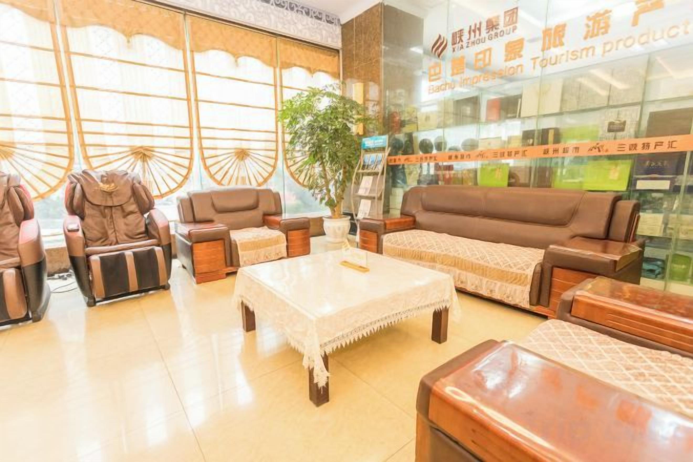 A lobby with seating arrangements, a coffee table, and a large window.
