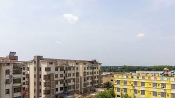 A multi-story residential building with balconies and a flat roof.