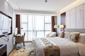 A hotel room with a bed, a desk, a chair, a TV, and a large window. - Yitian Hotel Jinxi (Jinxi)