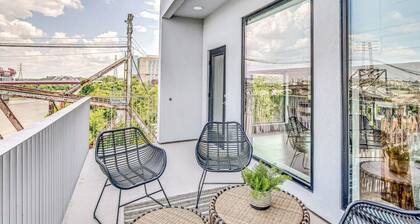 Penthouse Condo with a River View - Walk to Downtown + Garage Parking